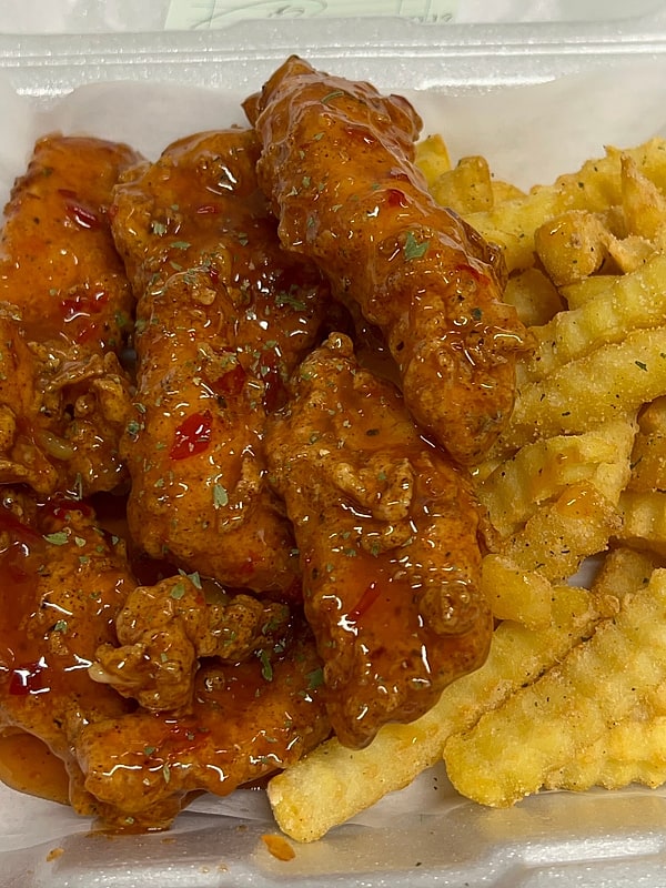 Sticky glazed chicken tenders over crinkle fries